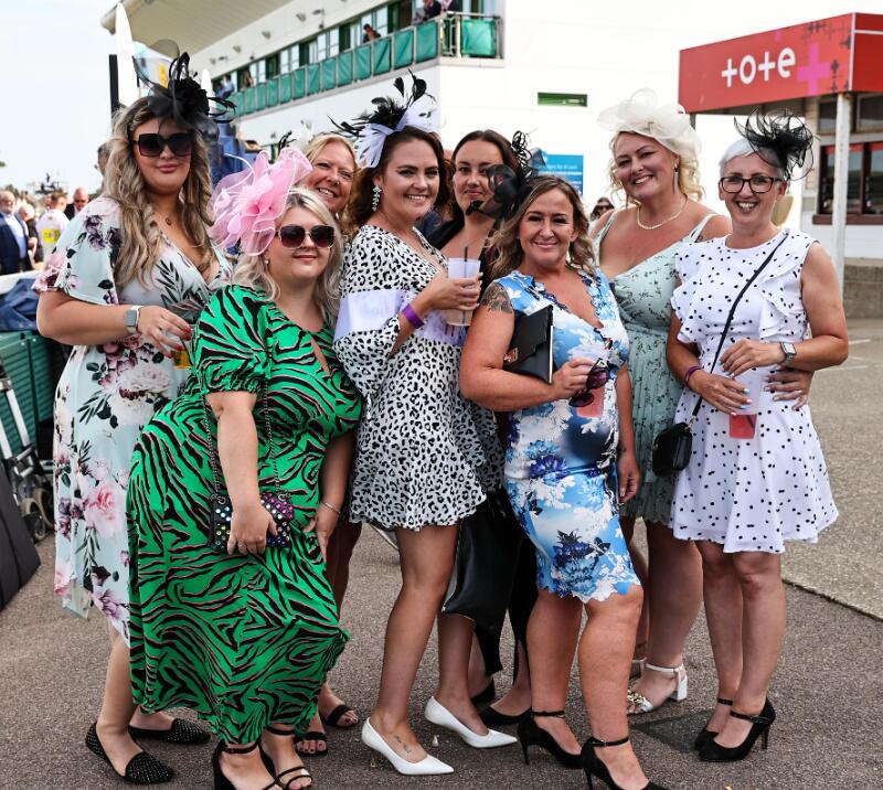 A bride to be poses with her bride tribe at her hen do at the races