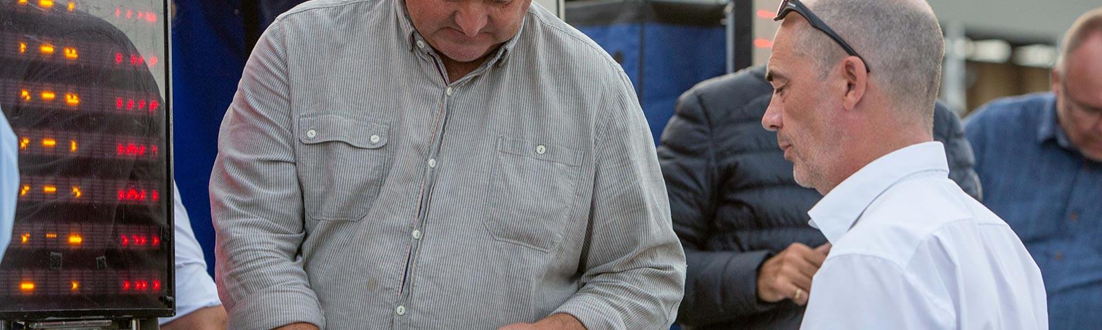 Racegoer placing a bet with a bookmaker.
