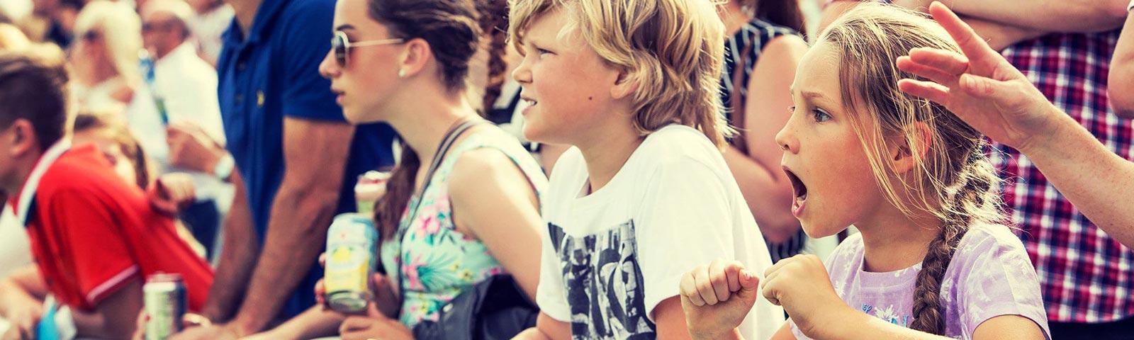 A view of the crowd at Great Yarmouth Racecourse as a youngster near the front cheers on her horse.